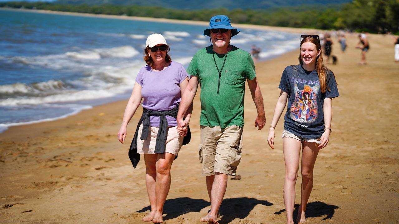 Sydney visitors Maria, Greg and Emily Dunn enjoy a tropical winter beach outing. Picture: Nuno Avendano