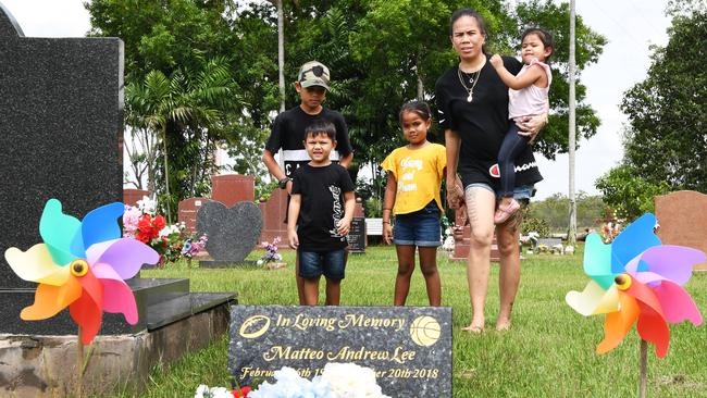 Chantelle Lee and her children with the temporary plaque at her son Matteo’s grave. She hoped to have the completed gravestone in time for his 21st birthday in February. Picture: Katrina Bridgeford.