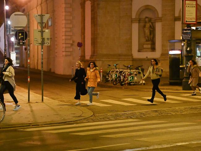 Women run away from the first district near the state opera following a shooting near a synagogue. Picture: AFP