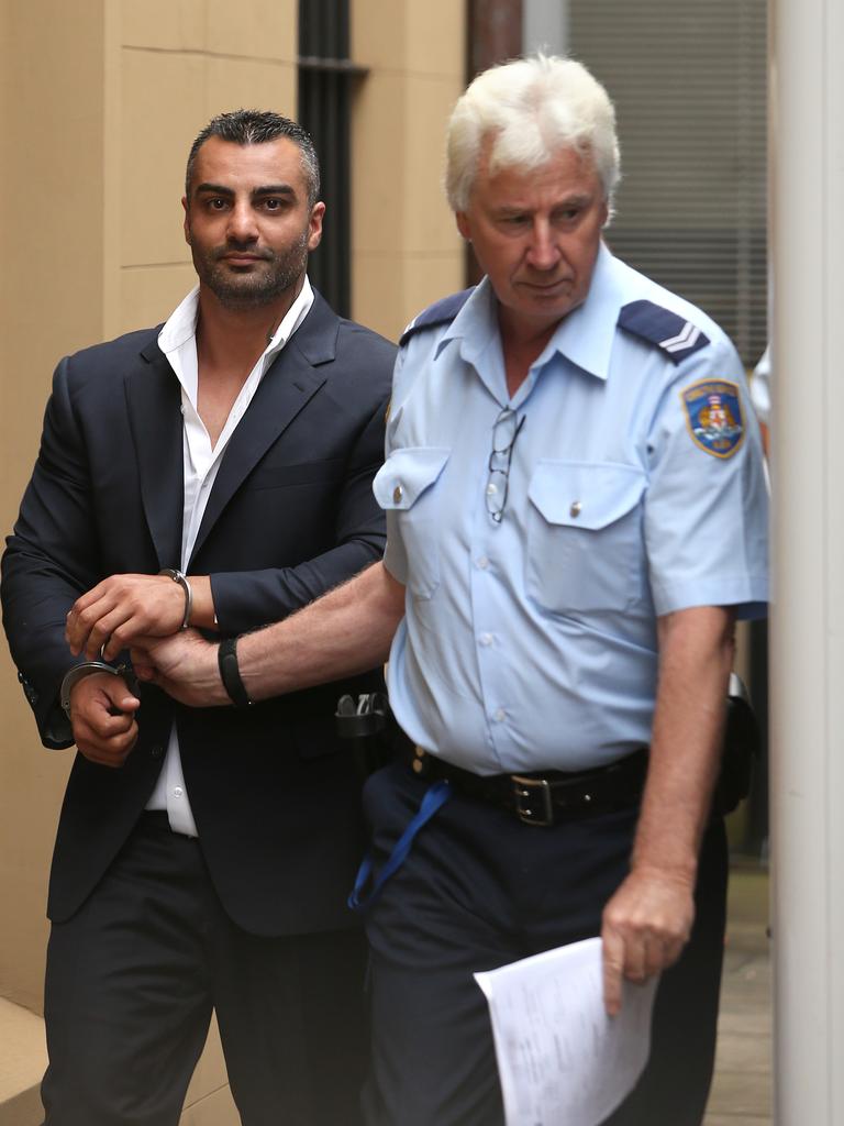 Mick Hawi smirks as he leaves Kings Street Courts in custody. Picture: Bradley Hunter