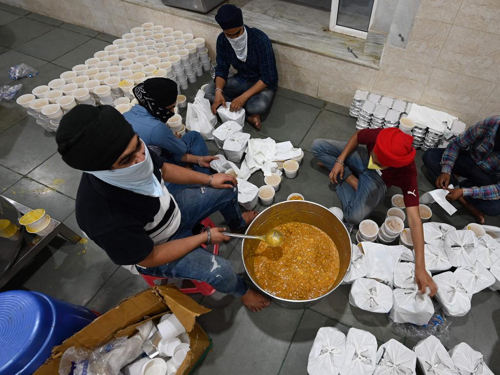 Volunteers prepare food for COVID-19 patients isolated at home, in the community kitchen of a Gurudwara (Sikh temple) in New Delhi. Picture: AFP