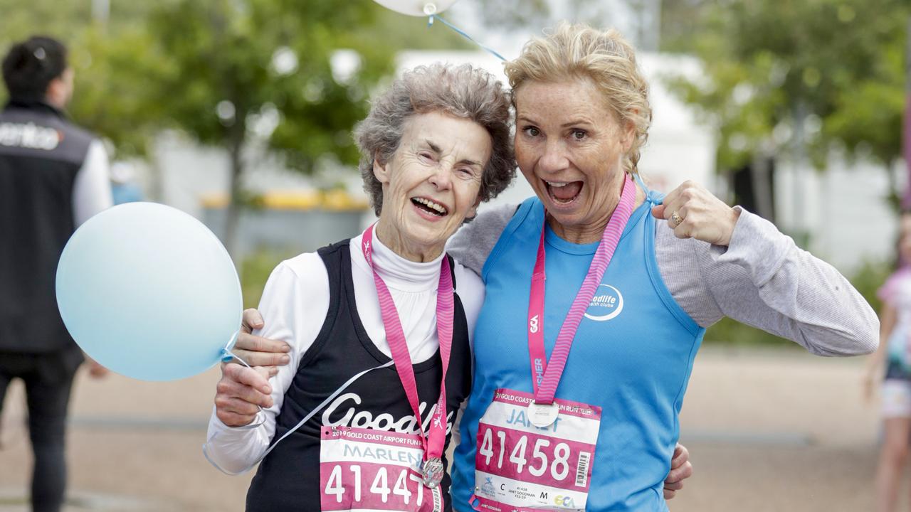 Marlene Phillips, from Ashmore who is turning 80 tomorrow celebrates with a friend at the finish the Gold Coast Airport Fun Run. Pics Tim Marsden