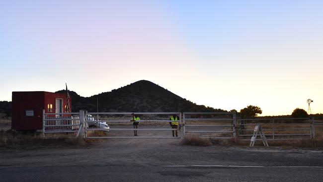 Security guards stand behind a locked gate at the entrance to the Bonanza Creek Ranch. (Photo by Sam Wasson/Getty Images)