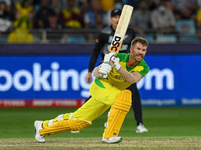 Australia's David Warner plays a shot during the ICC menâs Twenty20 World Cup final match between Australia and New Zealand at the Dubai International Cricket Stadium in Dubai on November 14, 2021. (Photo by INDRANIL MUKHERJEE / AFP)