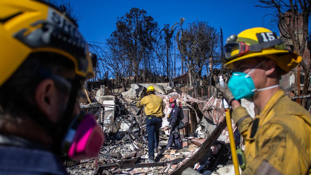 Firefighters inspect a burned house from the Palisades Fire in the Pacific Palisades neighborhood on January 16. Picture: Apu Gomes / Getty