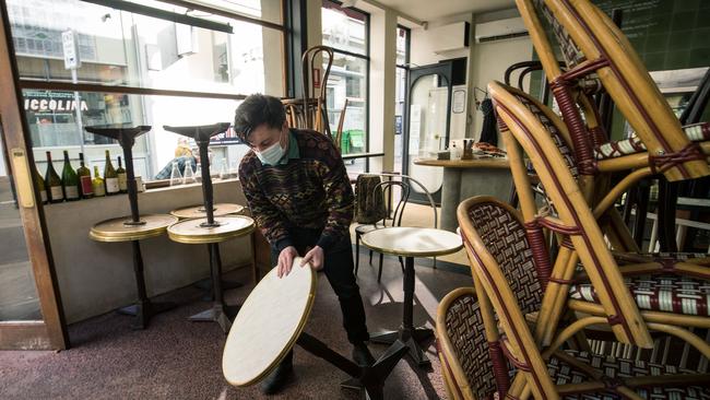 Staff at Kirk’s Wine Bar in Melbourne’s CBD prepare to resume trading. Picture: Getty Images