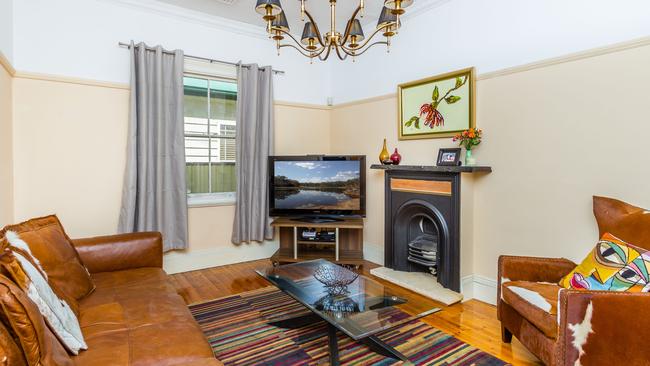 The loungeroom has plenty of character, with timber floors and an original fireplace.