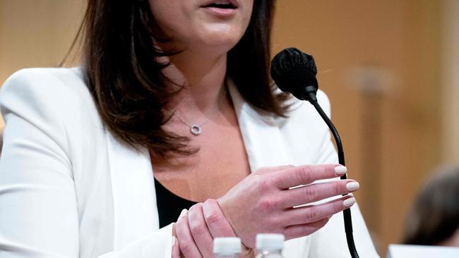 Cassidy Hutchinson, a top aide to former White House Chief of Staff Mark Meadows, holds her wrist while describing the actions of former US president Donald Trump.