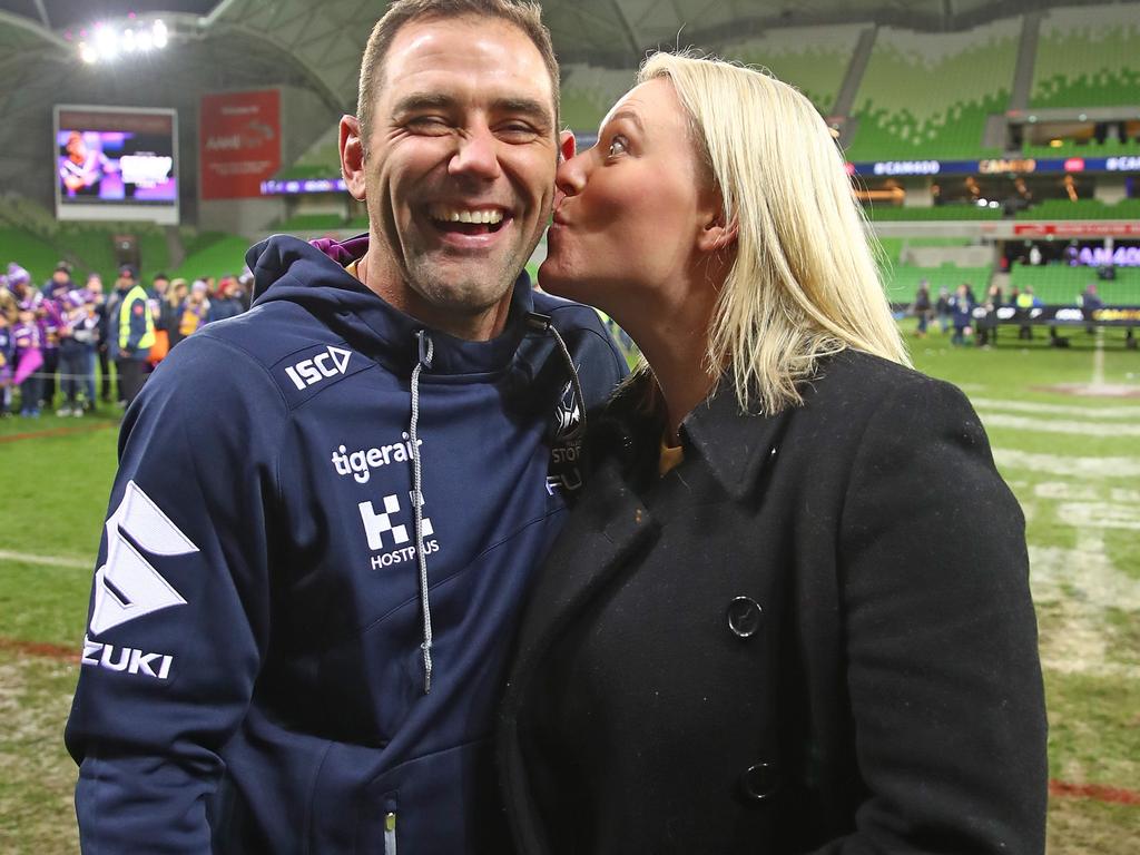 Melbourne Storm Captain Cameron Smith is kissed by his wife Barbara Smith as he leaves the field after becoming the first player to reach 400 matches.