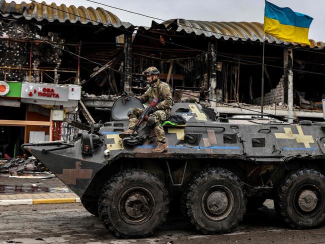 A Ukrainian soldier patrols in an armoured vehicle a street in Bucha. Picture: Ronaldo Schemidt/AFP