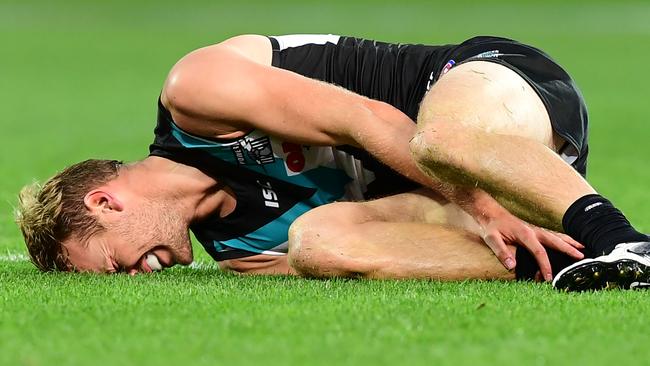 Jack Watts of Port Adelaide hold his ankle in agony after a tackle from Carlton’s Dale Thomas in Round 2. Picture: Mark Brake/Getty Images