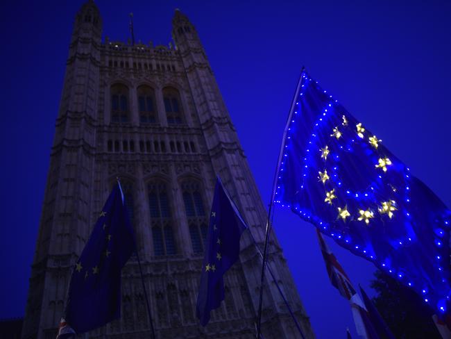 Demonstrators wave lit up pro-EU flags outside the Houses of Parliament. Picture: Getty