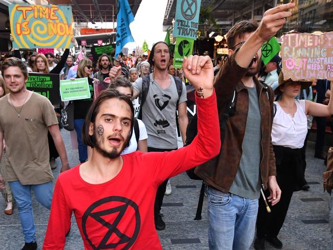 Environmental activist Eric Herbert (centre) with the Extinction Rebellion protesters as they march down the Queen Street Mall in Brisbane on August 6. Picture: AAP/Darren England