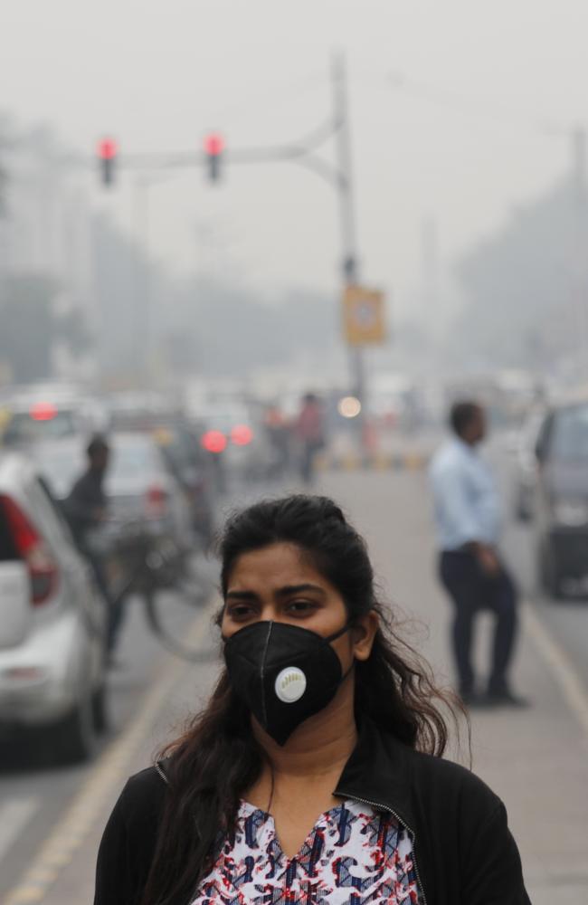 A commuter walks wearing a pollution mask amid thick layer of smog in New Delhi, India, on Thursday. Picture: Manish Swarup