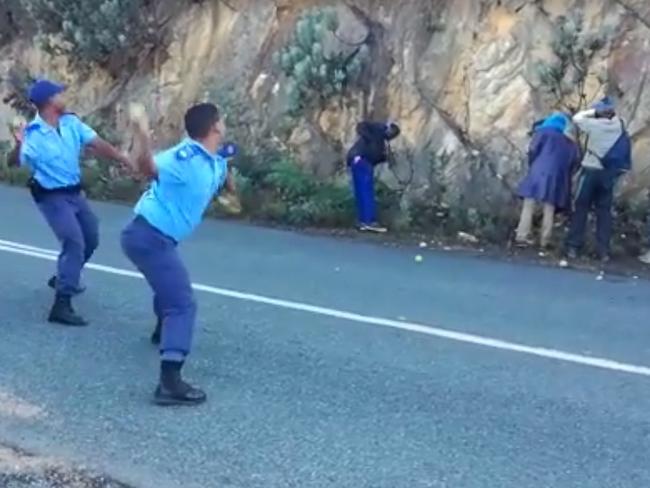 South African police throw apples at alleged thieves