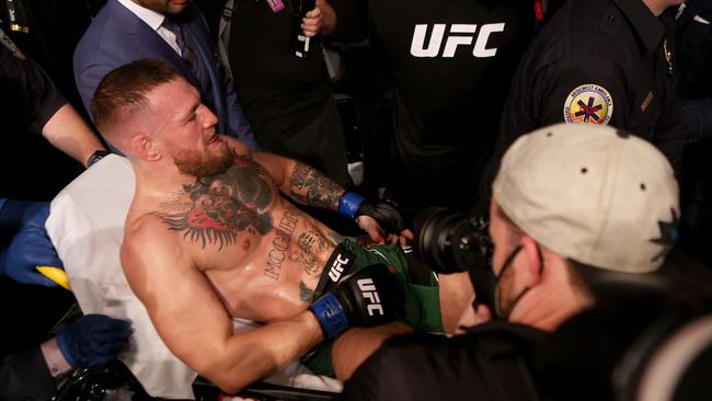 Conor McGregor carried out of the arena on a stretcher at UFC 264. Picture: Stacy Revere/Getty