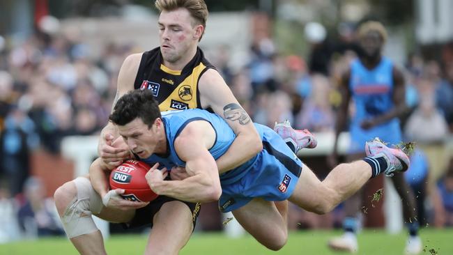 A flying James Mathews is tackled by Glenelg’s Liam Wisdom at the Bay in Round 9. Picture: David Mariuz/SANFL