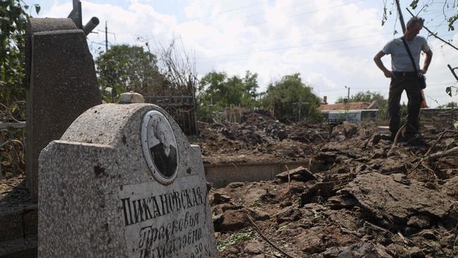 A resident examines the aftermath of a Russian strike on Odessa during which a missile landed in a cemetery. Picture: AFP