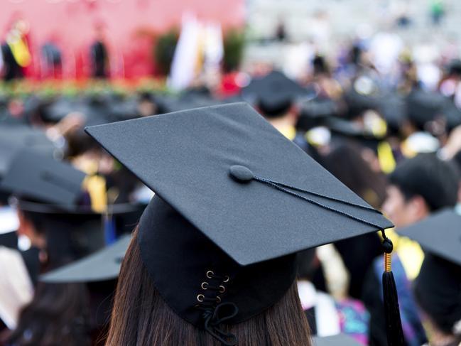 Rear view of graduation caps during commencement.