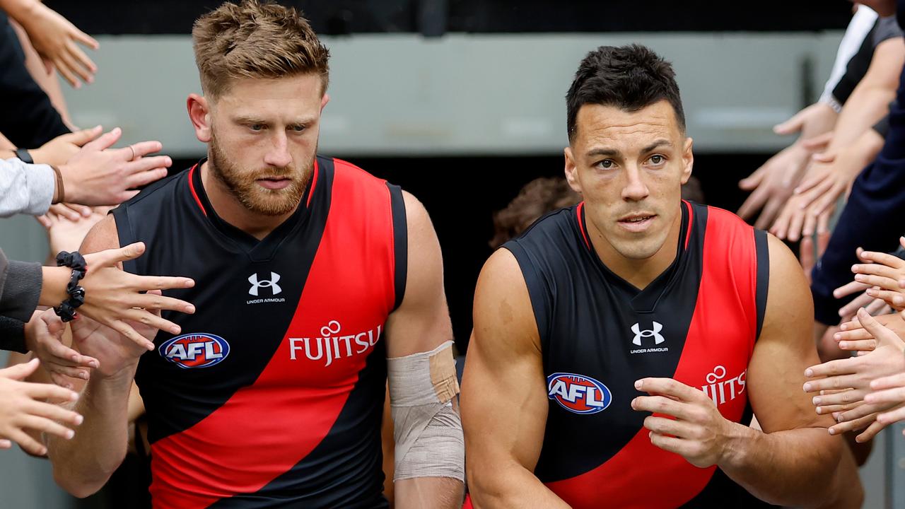 MELBOURNE, AUSTRALIA - MARCH 19: Jayden Laverde and Dylan Shiel of the Bombers lead the team up the race during the 2023 AFL Round 01 match between the Hawthorn Hawks and the Essendon Bombers at the Melbourne Cricket Ground on March 19, 2023 in Melbourne, Australia. (Photo by Dylan Burns/AFL Photos via Getty Images)