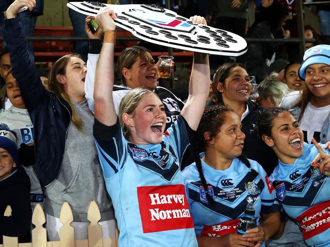 Maddison Studdon of the Blues holds the shield as she celebrates victory with the crowd during the Women's State of Origin match between New South Wales