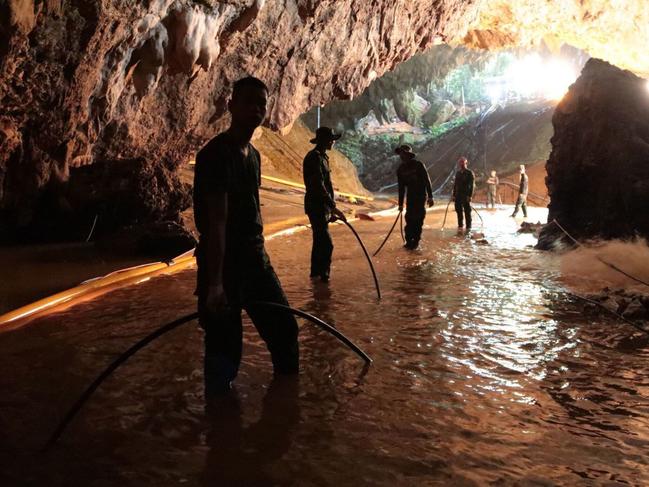 In this undated photo released by Royal Thai Navy on Saturday, July 7, 2018, Thai rescue teams arrange water pumping system at the entrance to a flooded cave complex where 12 boys and their soccer coach have been trapped since June 23, in Mae Sai, Chiang Rai province, northern Thailand. The local governor in charge of the mission to rescue them said Saturday that cooperating weather and falling water levels over the last few days had created appropriate conditions for evacuation, but that they won't last if it rains again.. (Royal Thai Navy via AP)