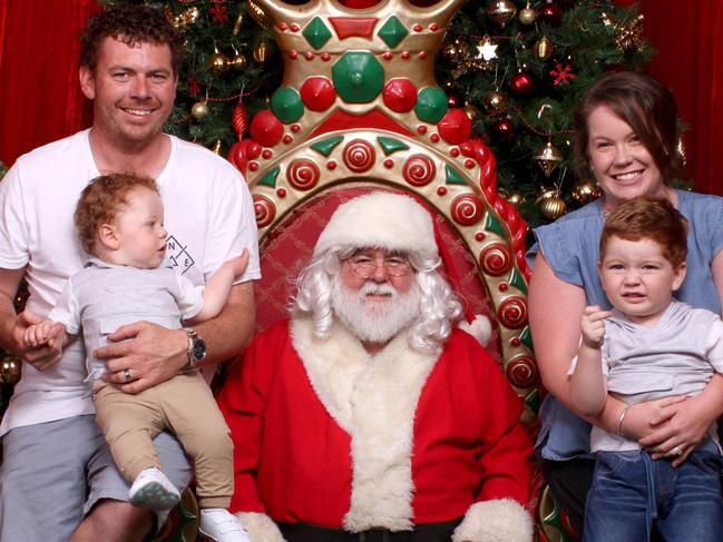 ***COPYRIGHT UNKNOWN USE AT OWN RISK**PIC FROM Hunter Valley Gardens /Caters News - (PICTURED: Ryder,2 with Santa. PIC TAKEN ON 06/12/17) -A mum was left red-faced after paying 5 for photos of her shy son meeting Father Christmas only to discover the tot was flipping his middle finger at the camera. Embarrassed mum-of-two Tammie Hopley, 29, only realised cheeky Ryders adorable protest when she showed the professional photographs to a friend.The hilarious images show a squirming Ryder, two, raising his middle finger at the camera while sat next to Santa with dad Matthew Hopley, 30 and brother Ledger, 10 months.SEE CATERS COPY