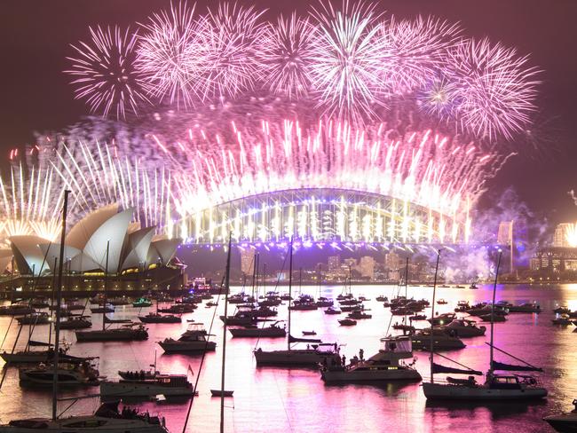 SYDNEY, AUSTRALIA - JANUARY 01: A fireworks display over the Sydney Harbour Bridge during New Year's Eve celebrations on January 01, 2021 in Sydney, Australia. Celebrations look different this year as COVID-19 restrictions remain in place due to the ongoing coronavirus pandemic. (Photo by Wendell Teodoro/Getty Images) *** BESTPIX ***