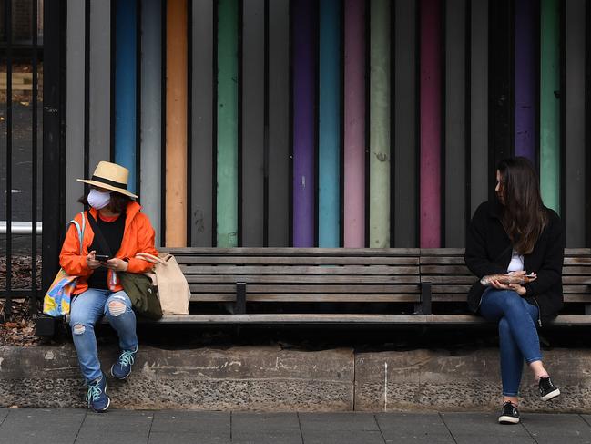 People wearing masks at a Sydney bus stop. Picture: Joel Carrett