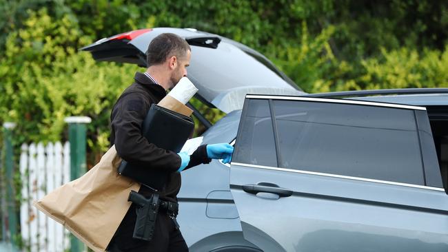 Detectives take away evidence from a scene in Norlane. Picture: Alison Wynd