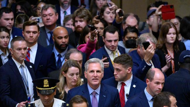 Kevin McCarthy walks from the House Chamber surrounded by supporters. Picture: AFP.