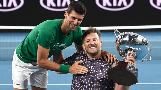 Novak Djokovic congratulates and hugs Alcott after beating Britains's Andy Lapthorne. Picture: AFP.