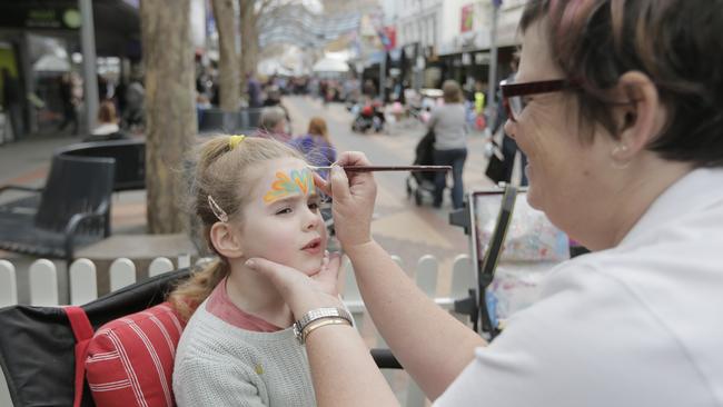 Armelle, 5, of Kingston, has her face painted by Peta Rogers from Face Your Fantasy at the Super Sidewalk Saturday event.