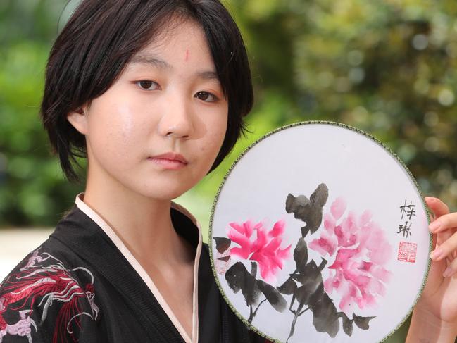 St Stephens students dressed in traditional costume perform in front of parents and friends to celebrate Chinese New Year.Year 7 student Vivian Shi with an ornamental fan. Picture Glenn Hampson