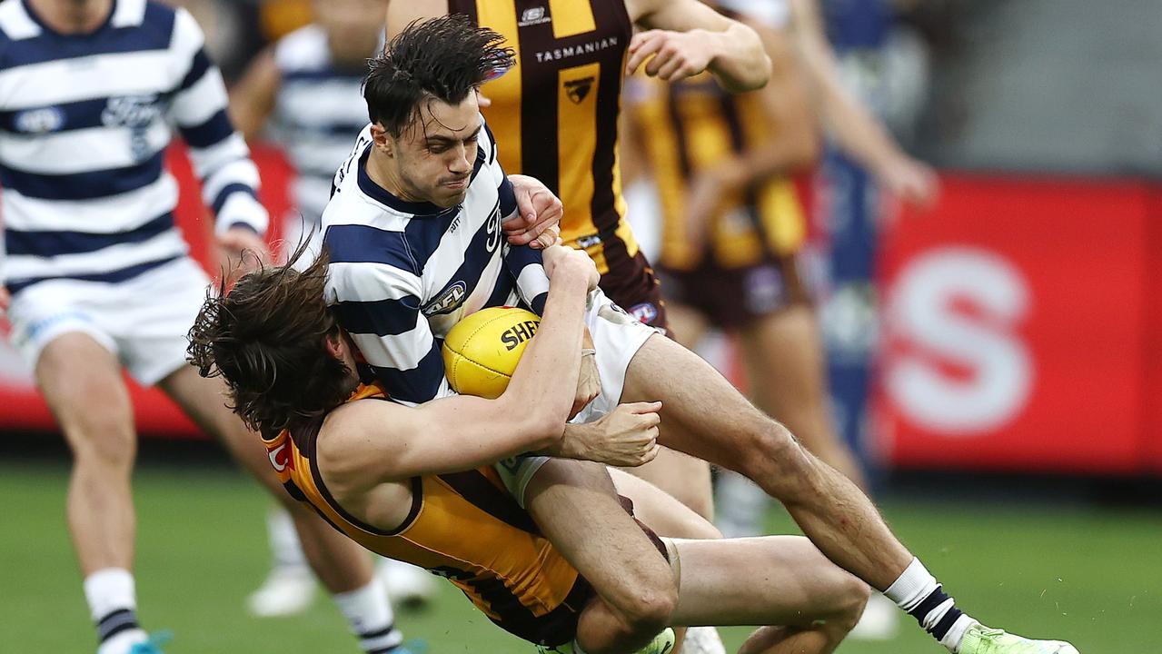 MELBOURNE. 10/04/2023. AFL. Round 4. Geelong vs Hawthorn at the MCG. Will Day of the Hawks tackles Brad Close of the Cats. Pic: Michael Klein