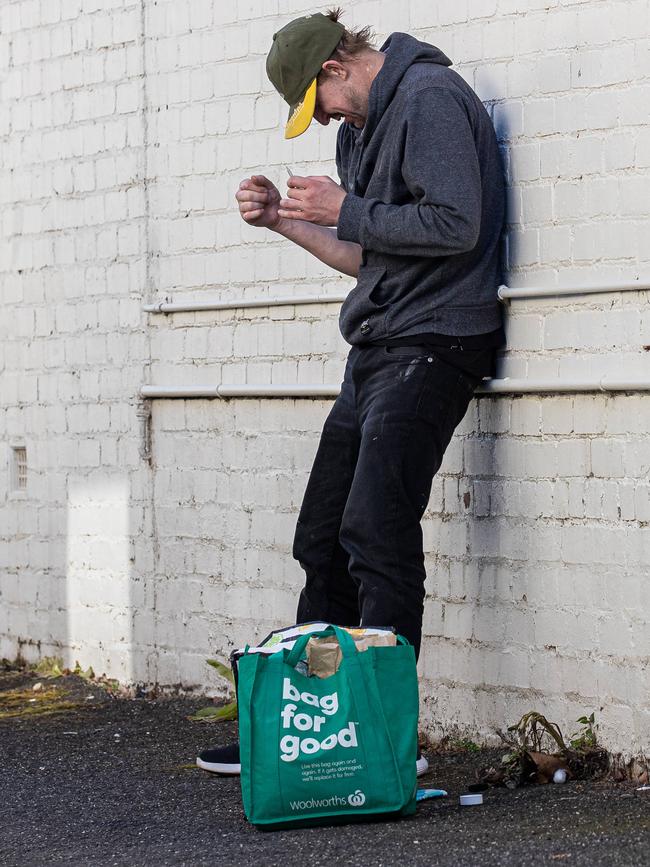 A man blatantly injects drugs in a Richmond alley. Picture: Jason Edwards