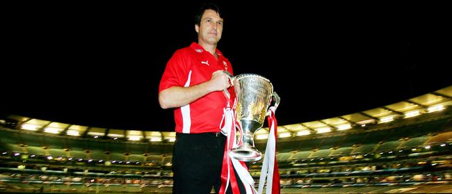 24 Sept 2005 AFL Grand Final. Sydney Swans vs West Coast Eagles at MCG. Coach Paul Roos walks from an empty MCG with the Premiership cup. - sport  trophy