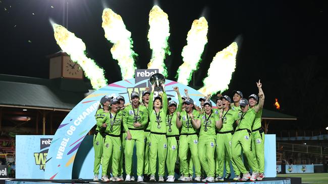 Rachael Haynes of the Sydney Thunder lifts the trophy as the team celebrate victory during the Women's Big Bash League 06 final against the Melbourne Stars at North Sydney Oval on Saturday. Picture: Ryan Pierse/Getty Images