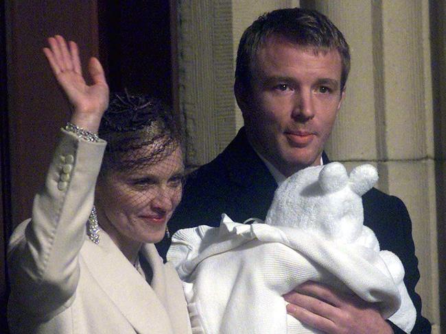 Proud parents ... Madonna and Guy Ritchie carrying their baby Rocco after his baptism in 2000. Picture: Supplied