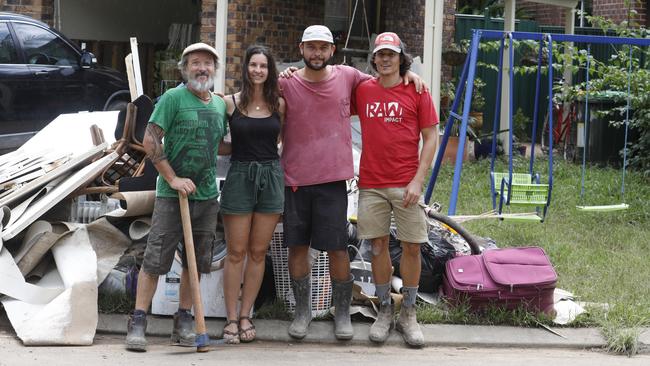 Cecile Dehant (second from left) outside her Mullumbimby home which was flooded this week, along with friends Lalo, Mathieu Carlot and Jonathan Richer, who were helping with the cleanup. Mullumbimby residents have been left with a large cleanup job after a destructive flood swept through the town, along with much of Northern NSW. Pictured on Friday, March 4, 2022. Picture: Liana Boss