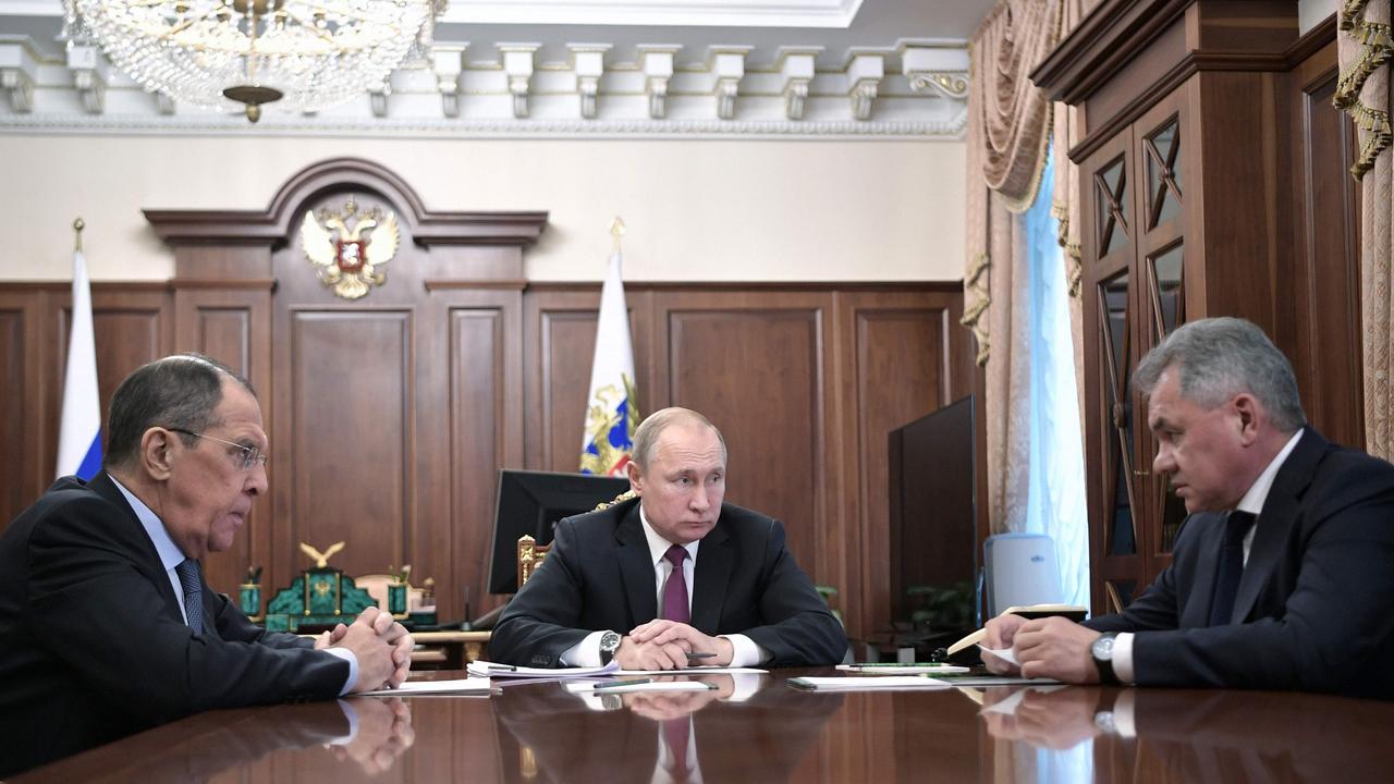 Russia's President Vladimir Putin attends a meeting with Russia's Foreign Minister Sergei Lavrov (left) and Defence Minister Sergei Shoigu in Moscow on the weekend. President Putin said Russia was suspending its participation in a key Cold War-era missile treaty in a mirror response to a US move the day before. Picture: Alexey Nikolsky 