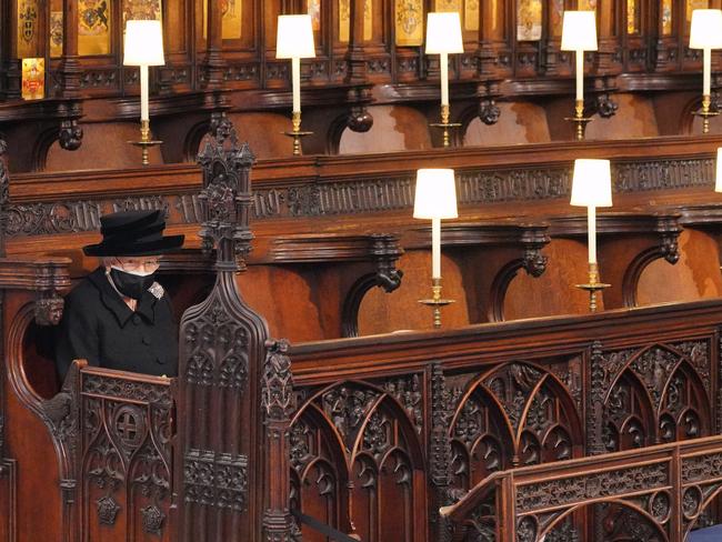 The Queen sits alone during Prince Philip’s funeral earlier this year. Picture: Getty Images