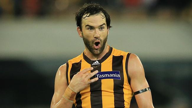 Jordan Lewis let Heath Grundy know how premiership medallions he has won, starting in 2008 ... Picture: Wayne Ludbey