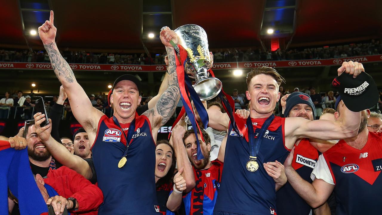 James Harmes and Bayley Fritsch celebrate with the premiership cup. Picture: AFL Photos/Getty Images