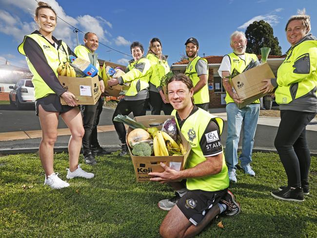 Coach of the Glenorchy District Football Club, Paul Kennedy has been delivering car packs to the local community alongside other volunteers (rear) LR Gennaveve Sullivan, Craig Kemp, Anita McPherson, Kendal Browning, Jordan West, Leigh McAdam and Nat Gulliver. Picture: Zak Simmonds