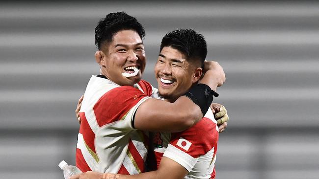 Japan's number 8 Kazuki Himeno (left) and fly-half Rikiya Matsuda celebrate after beating Samoa. Picture: AFP