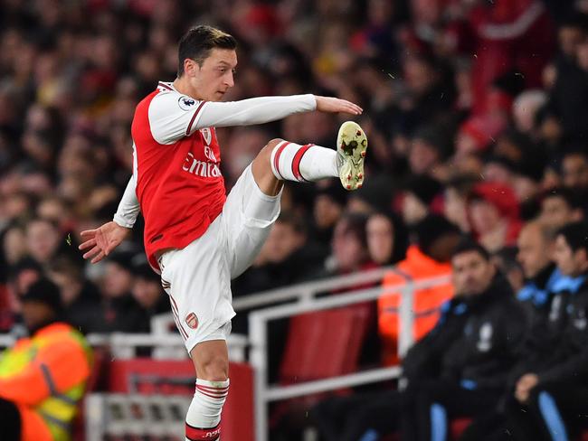 Arsenal's German midfielder Mesut Ozil reacts to his substitution by kicking his gloves along the touchline during the English Premier League football match between Arsenal and Manchester City at the Emirates Stadium in London on December 15, 2019. (Photo by Ben STANSALL / AFP) / RESTRICTED TO EDITORIAL USE. No use with unauthorized audio, video, data, fixture lists, club/league logos or 'live' services. Online in-match use limited to 120 images. An additional 40 images may be used in extra time. No video emulation. Social media in-match use limited to 120 images. An additional 40 images may be used in extra time. No use in betting publications, games or single club/league/player publications. /