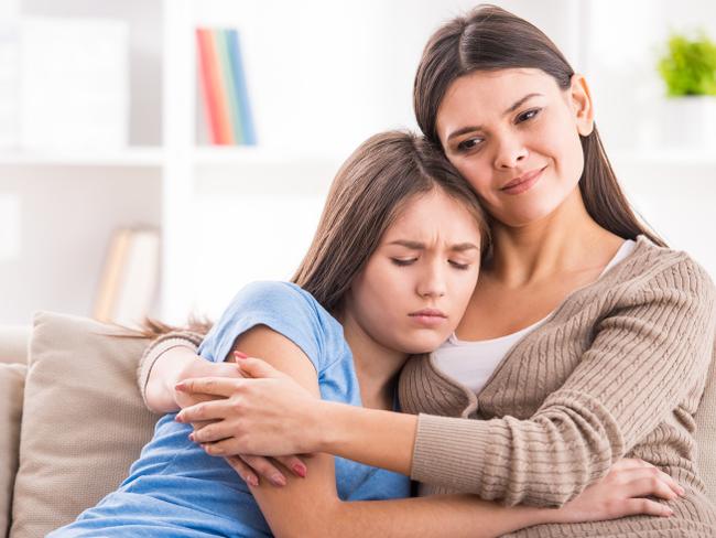 RendezView. Mother and teen daughter are hugging after quarrel on sofa at home. (Pic: iStock)