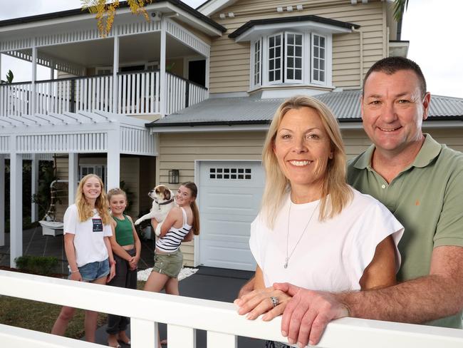 Troy and Sally McMillan with their kids Tayla, 15, Siena, 13, and Bella, 11, at their Kedron home they are selling. Picture: Liam Kidston