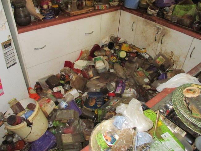 A filthy kitchen where years worth of used food containers, rubbish anddirty plates have been dumped and forgotten. These are among the hoarders'collections that O'Sheas cleaning company tackles. Picture: O'Sheas